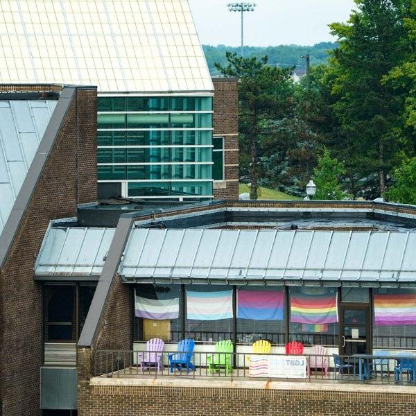 image of the LGBT Center's balcony, decorated in different LGBT affiliated pride flags.