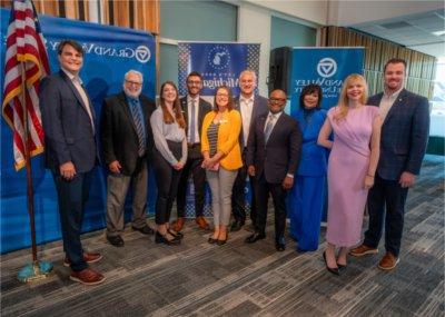 Chief Growth Officer Hilary Doe, President Philomena V. Mantella and Vice President for Enrollment Development and Educational Outreach B. Donta Truss pose for a photo with another recipients of the Make MI Home grant.