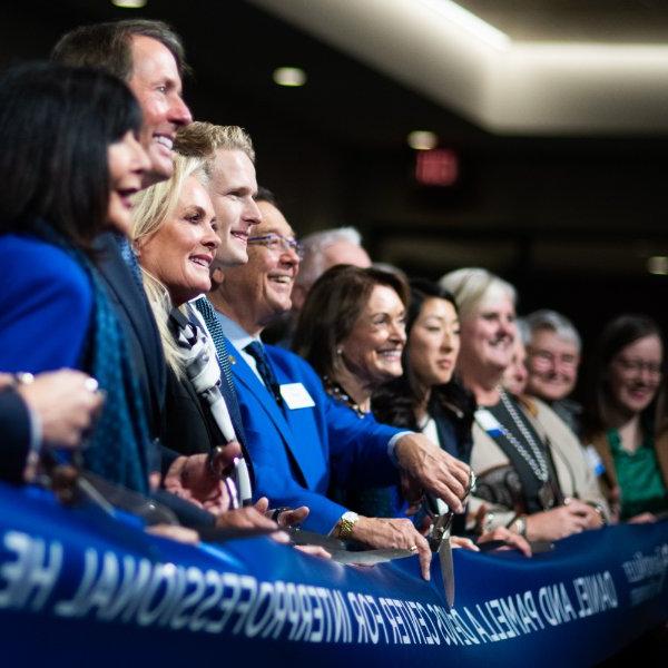 A group of GVSU and community leaders cutting a ribbon.