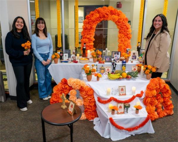 (From left) Thalia Guerra-Flores, Lucero Arizaga and Jackelyn Palmas, pose for a picture with the Día de Muertos (Day of the Dead) altar.