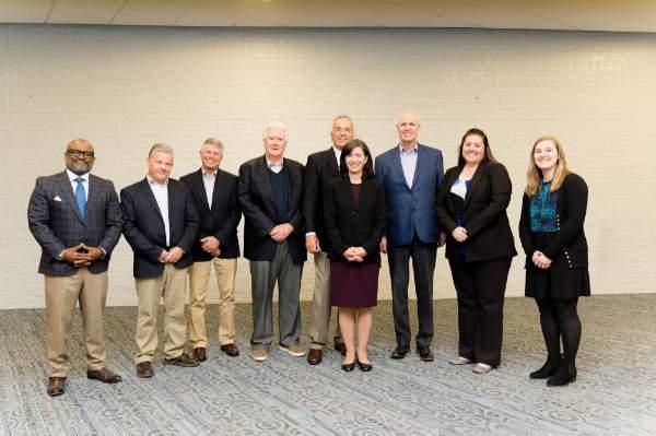 From left are Lyndsey Schab, Samantha Mayse, Thompson Foundation trustees John Cleary, Cathy Kunkel, Joe Aristeo, Brian Cooney, Kevin Brender and Curt Little, and B. Donta Truss, vice president for Enrollment Development and Educational Outreach.