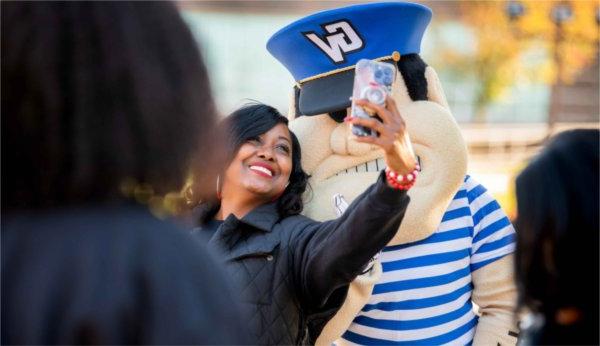  A person takes a selfie with Louie The Laker.