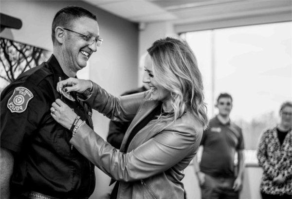  A member of the GVSU Police receives a badge during a swearing-in ceremony.