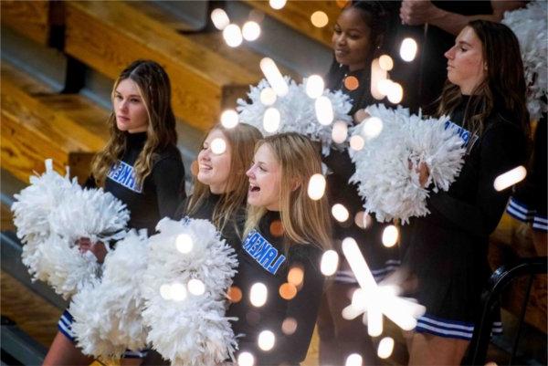  Cheerleaders perform near festive sparks.