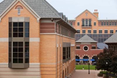 exterior view of the DeVos Center, with green grass in the center