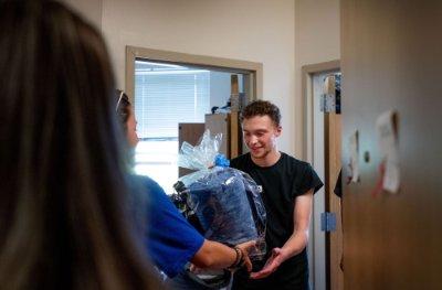 Connor Pung receives a gift basket in his dorm room.