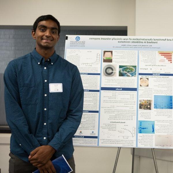 Micah Fernando pictured in front of his research poster