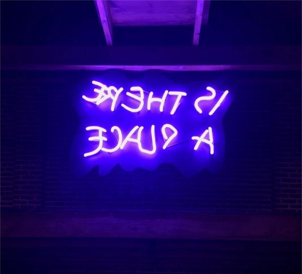 Katya Grokhovsky's neon sign "Is there a place" in purple tones