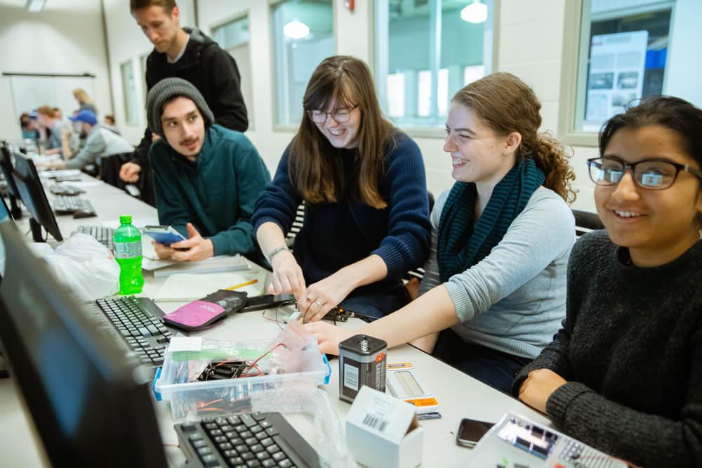 Four students work on an engineering project in the Keller Engineering labs.