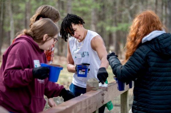 Jedaiah Armour, center, and fellow students from Byron Center Charter School volunteered with Michigan Cares 4 Tourism at the Muskegon Luge Adventure Sports Park and Muskegon State Park on April 19.