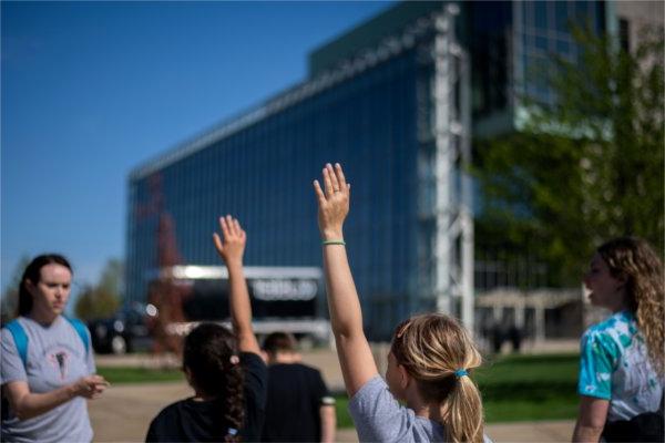 Endeavor Elementary School students raise their hands to answer questions while walking to the Mary Idema Pew Library. The students were part of a multicultural leadership team that visited the Allendale Campus.