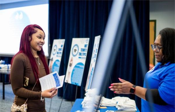 Raven McClinon, assistant director for TRIO STEM, left, talks with Skyy Figures, a sophomore sonography student, during the National TRIO Day celebration February 19.