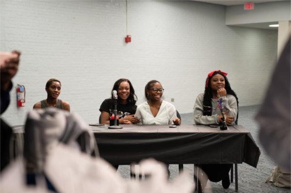 team of three students get ready for a question during a quiz bowl