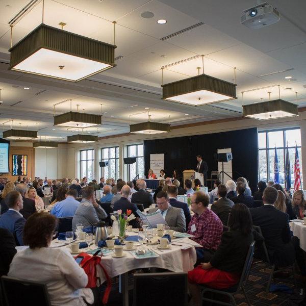 room of round tables with people seated at nearly every chair; L. William Seidman Center, World Trade Week conference from 2018