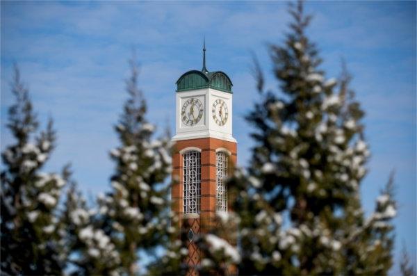 The GVSU Cook Carillon Tower surrounded by snow-covered Trees. 