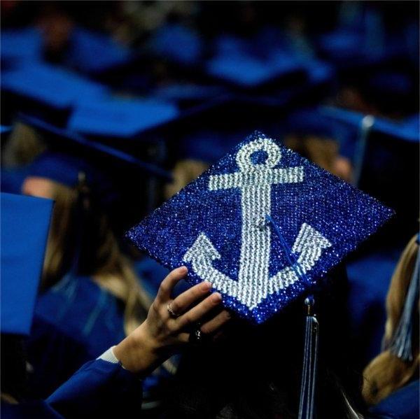 The top of a graduation cap, bedazzled with an anchor.