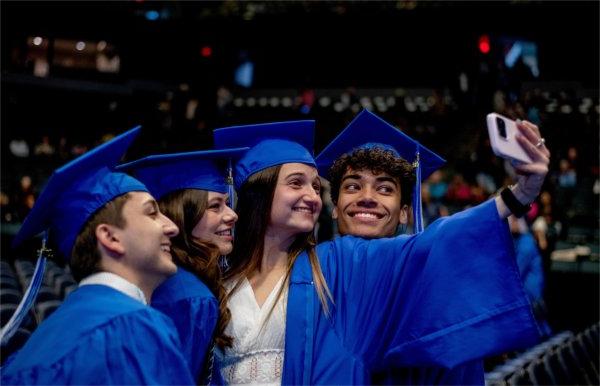 Graduating students take a selfie together.