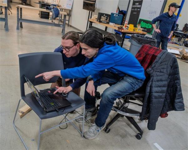 Engineering students Joshua Howery, left, and Quentin Brook practice for the FANGV Ri3D Robotics Competition at the Shape Corp. Innovation Design Center on February 5. 