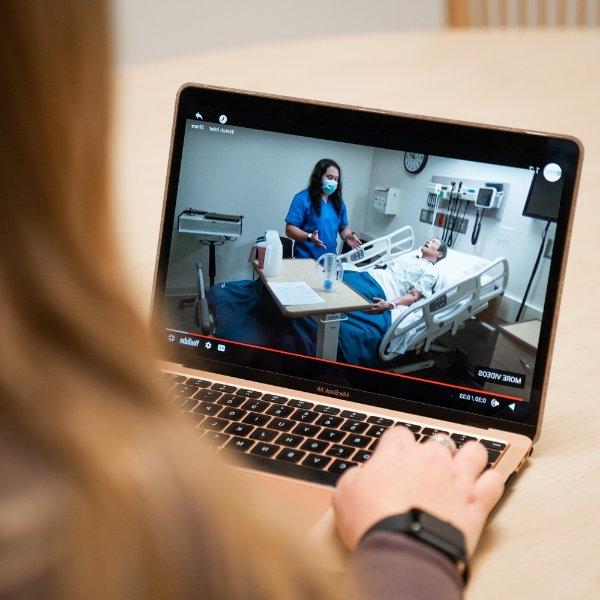 Computer screen showing Doug Ayers with a mannequin in the Simulation Center