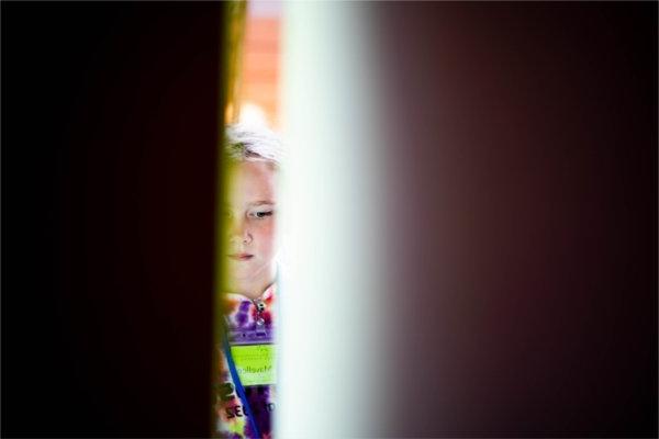  A student is seen through a crack in their student project. 