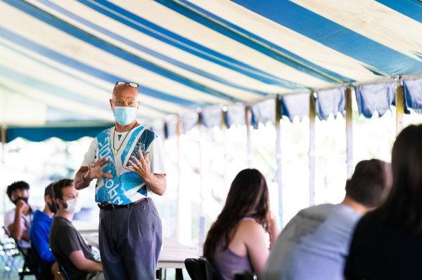 John Kilbourne, professor of movement science, teaches a class under a tent near Kindschi Hall of Science. 