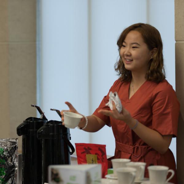 Ruixuan Ran, a senior from China who is majoring in accounting and international business, hosted a tea table for area business leaders who are learning best practices for doing business abroad.