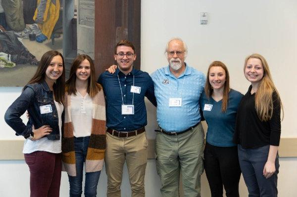 group of six people standing posing for photo