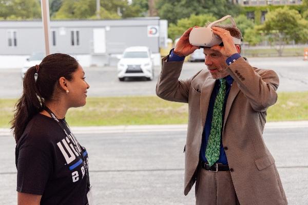 Mary Free Bed CEO Kent Riddle tries a VR tour of the new Joan Secchia Children's Rehabilitation Hospital during a demonstration on August 15 at the groundbreaking ceremony for the hospital in downtown Grand Rapids.  