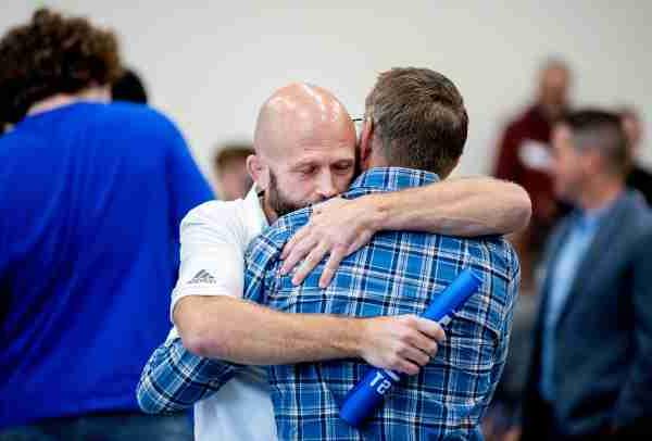 Two people hug at an event.