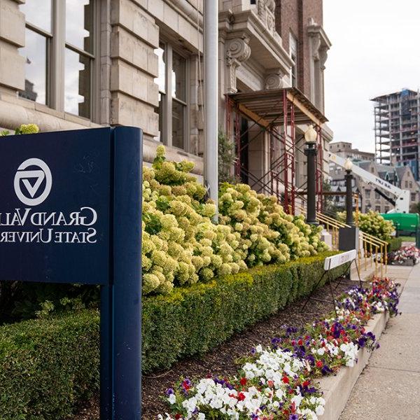 GVSU sign outside Detroit Center building; construction in background