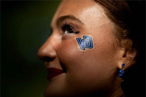  An up close photo of a GV sticker on a student's cheek. 