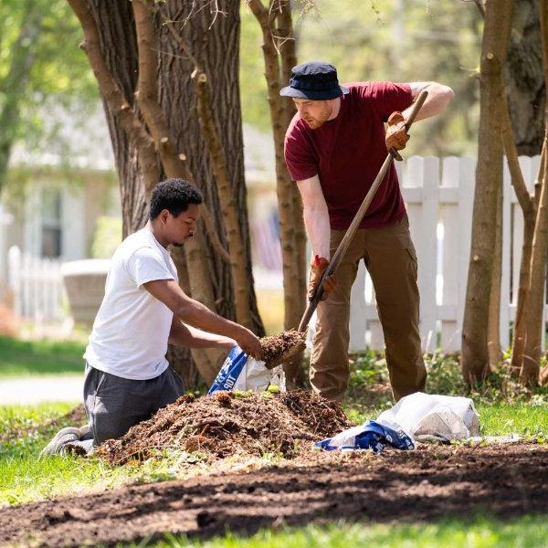 GVSU volunteers clean up a yard.