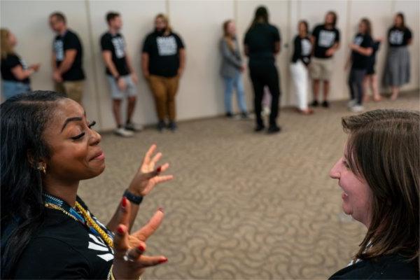 Morgan Dailey, right, and Lauren Wenstrup, talk during the West Michigan Teacher Collaborative Summer Institute at the Eberhard Center in Grand Rapids on July 22. Dailey is the coordinator and Wenstrup is the administrative assistant for the West Michigan Teacher Collaborative.