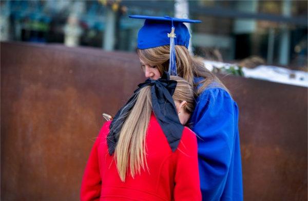  A graduate and her daughter share a moment. 