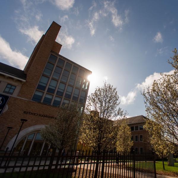 Sun shining behind Seidman College of Business building at Grand Valley State University