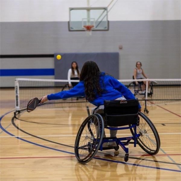 Students participate in a game of wheelchair pickleball.