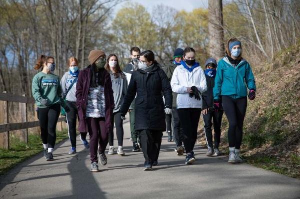 Provost Maria Cimitile walks with students to the boat launch area at the Grand Ravines North County Park.