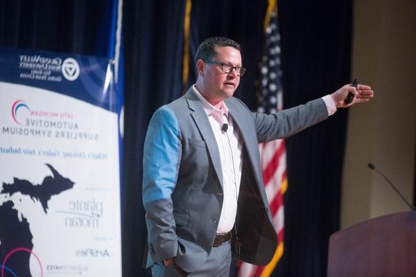 Gentex CEO Steve Downing gestures to a crowd