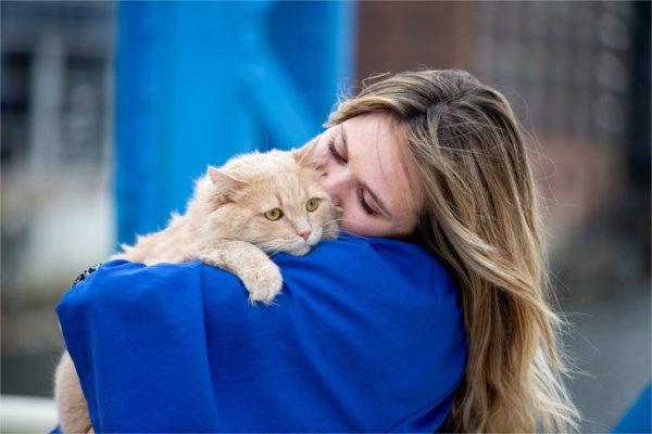  A graduate snuggles with her cat. 