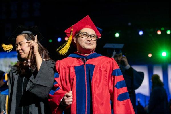   Graduates smile after receiving their diplomas. 