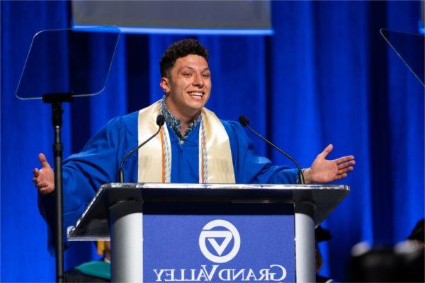   A student speaks at a lectern. 