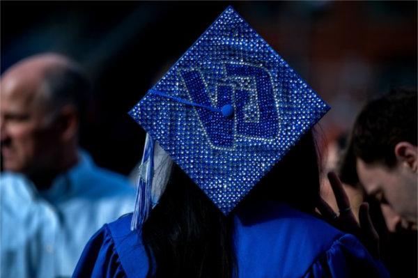 A bedazzled cap with the letters GV adorn the mortarboard.  