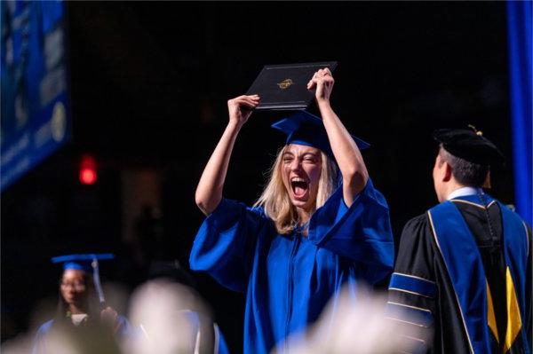  A graduate celebrates as they cross the stage.