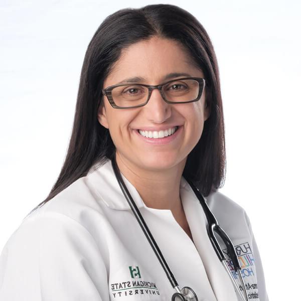 headshot: Dr. Mona Hanna-Attisha in lab coat