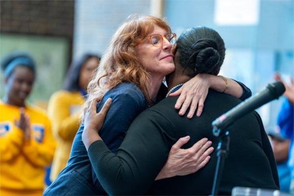 Melissa Baker-Boosamra, hugs Tania Belcher after Belcher's remarks at the Election Day Celebration. 