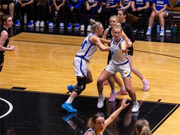 Rylie (Right)  stays on her girl as she fights through the double screen at the top of the key, while Mackenzie (Left) keeps a sharp eye on Parkside&rsquo;s next move, ready to respond with precise defense.