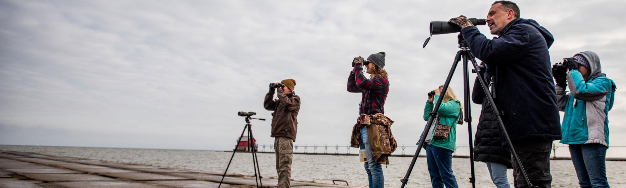 GVSU Biology students studying ornithology on Lake Michigan.