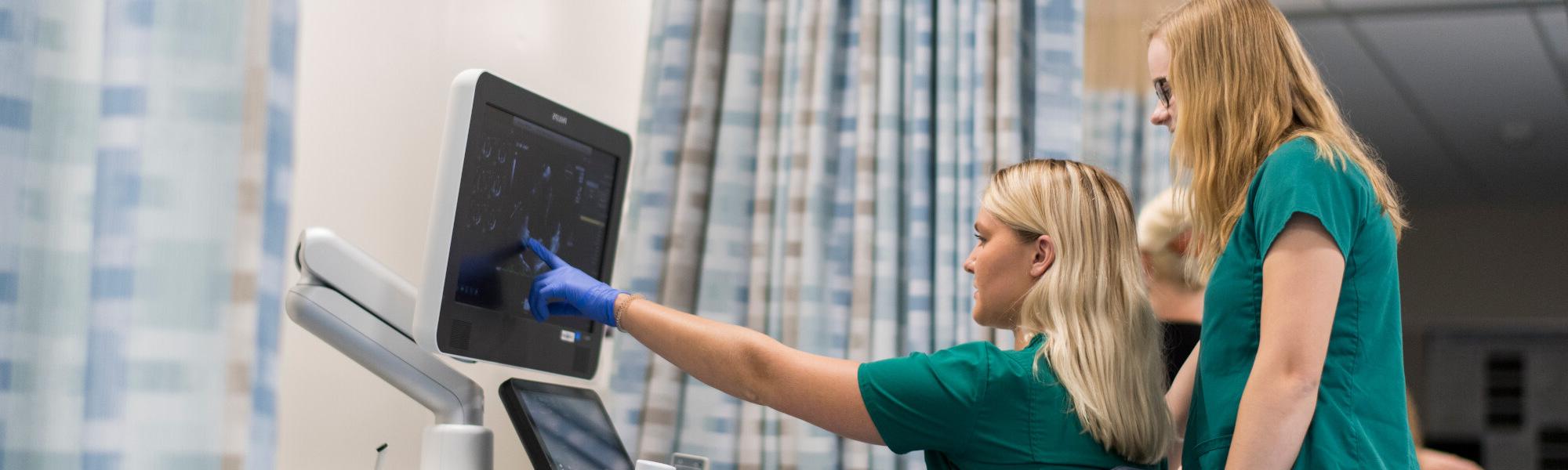 Photo of GVSU sonography students at a GVSU simulation lab Grand Rapid's Health Hill.